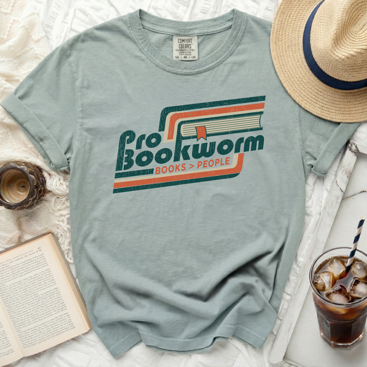Green t-shirt with "Pro Bookworm Books > People" graphic and retro stripes.