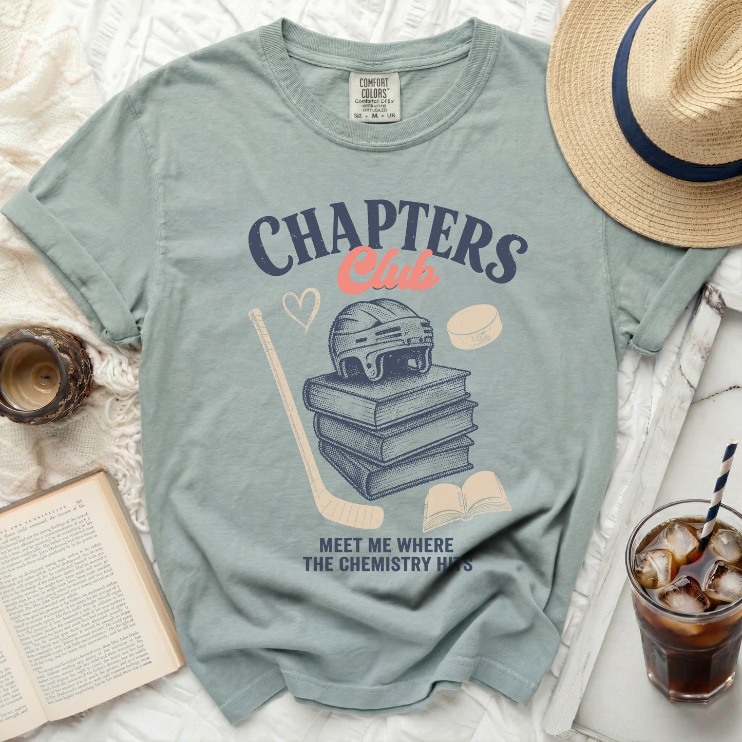 T-shirt graphic with books, hockey gear, and text "CHAPTERS CLUB".