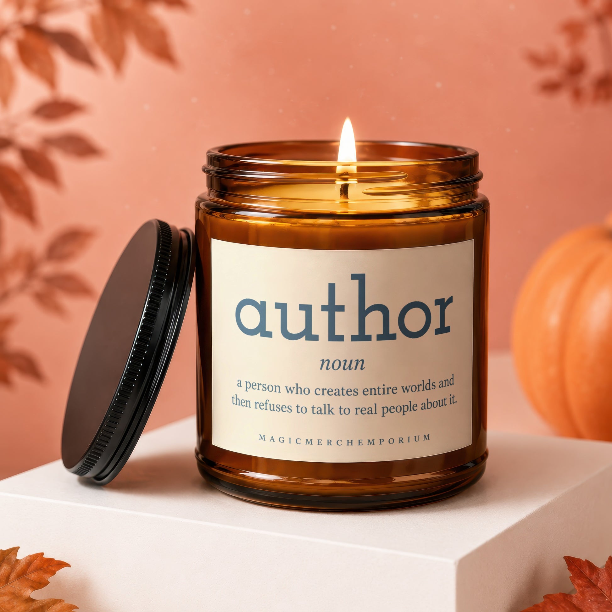 Amber candle with "author: a person who creates entire worlds and then refuses to talk to real people about it."