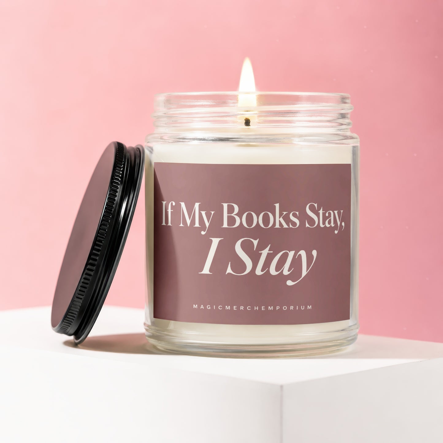 Lit candle in glass jar with lid off, reads "If My Books Stay, I Stay".