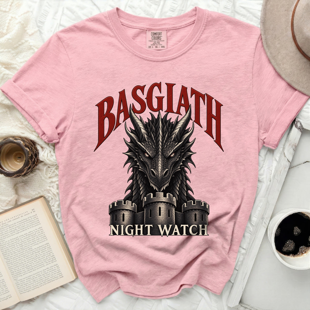 Pink t-shirt with arched "BASGIATH" text over a dragon and "NIGHT WATCH" text.