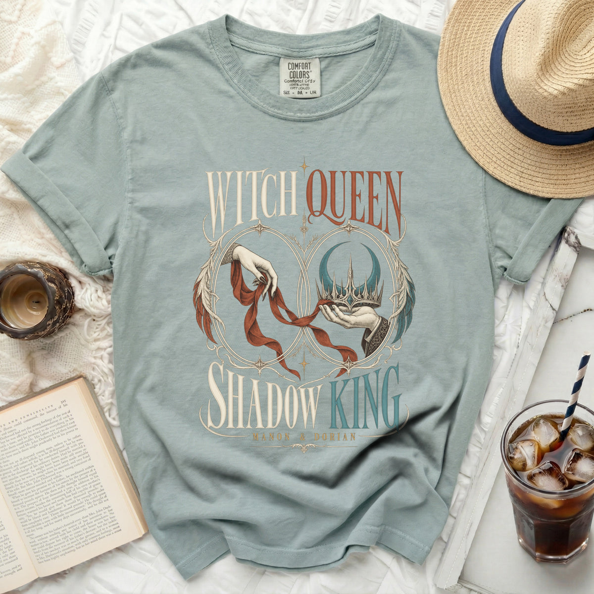 Light blue t-shirt with "Witch Queen Shadow King" graphic, featuring hands and crowns.