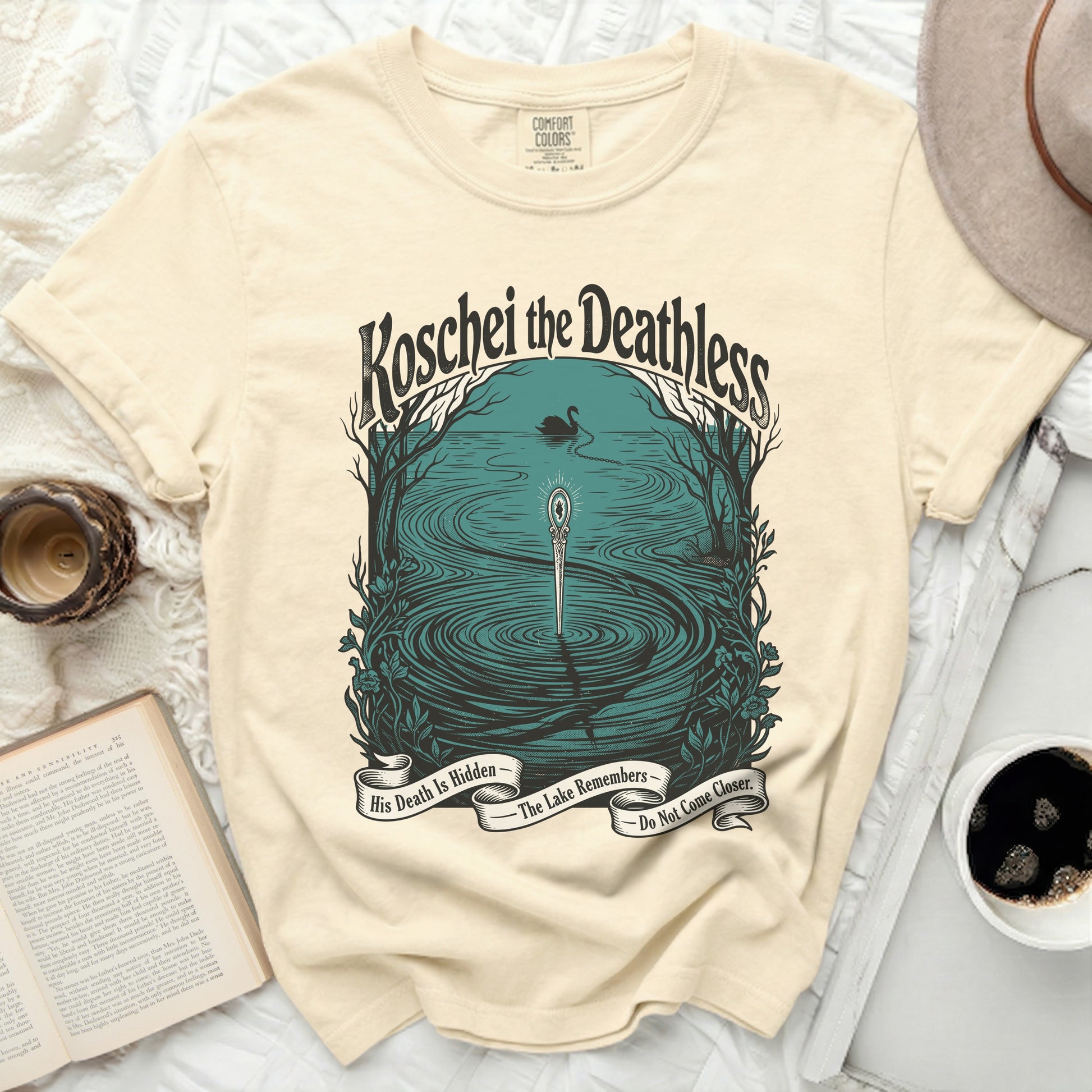 Cream t-shirt with "Koschei the Deathless" graphic and text banners.