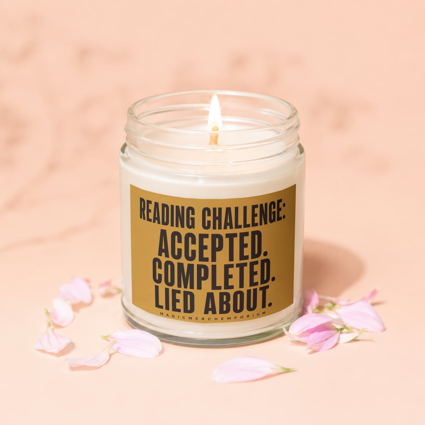 Lit candle with "Reading Challenge: Accepted. Completed. Lied About." text and pink petals.