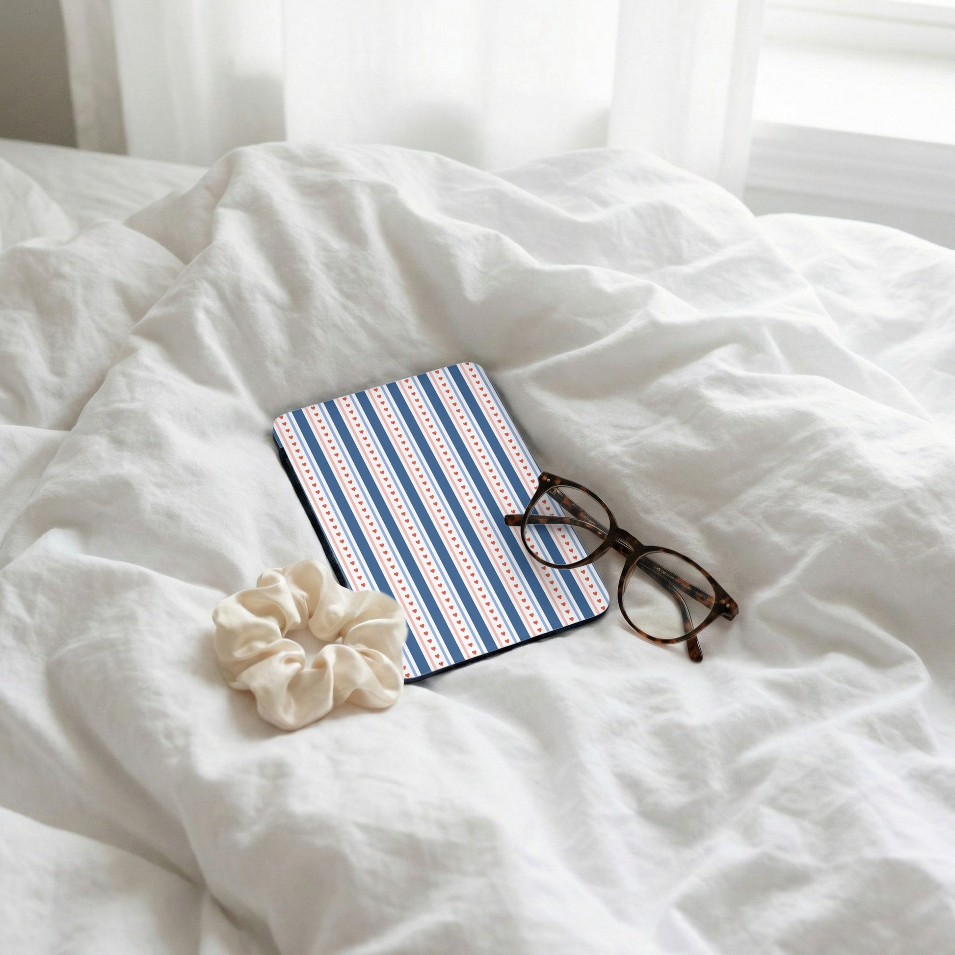 Stylish Blue and Red Stripes Notebook on Bed Scene