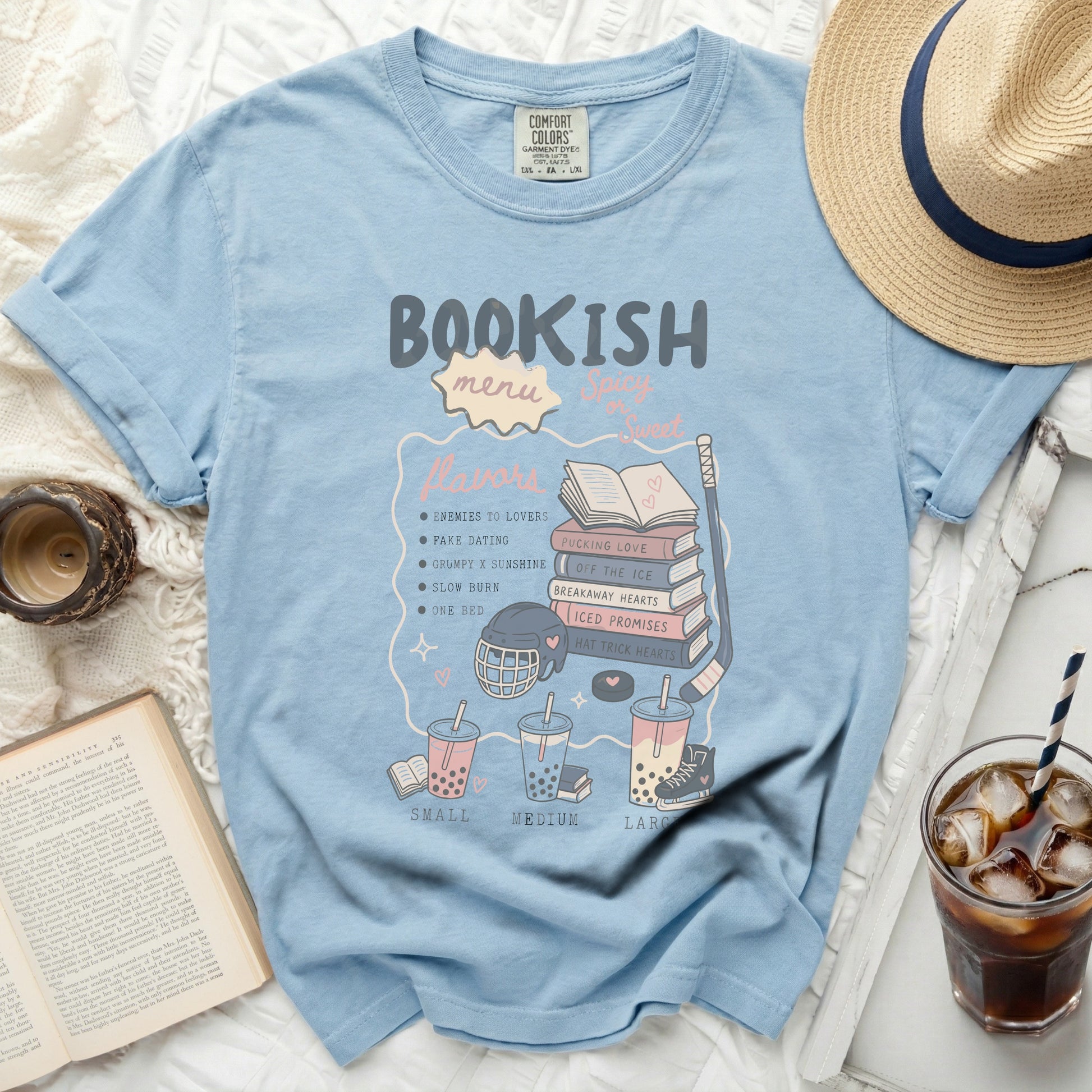 Light blue t-shirt with "Bookish Menu" graphic, listing romance novel tropes.