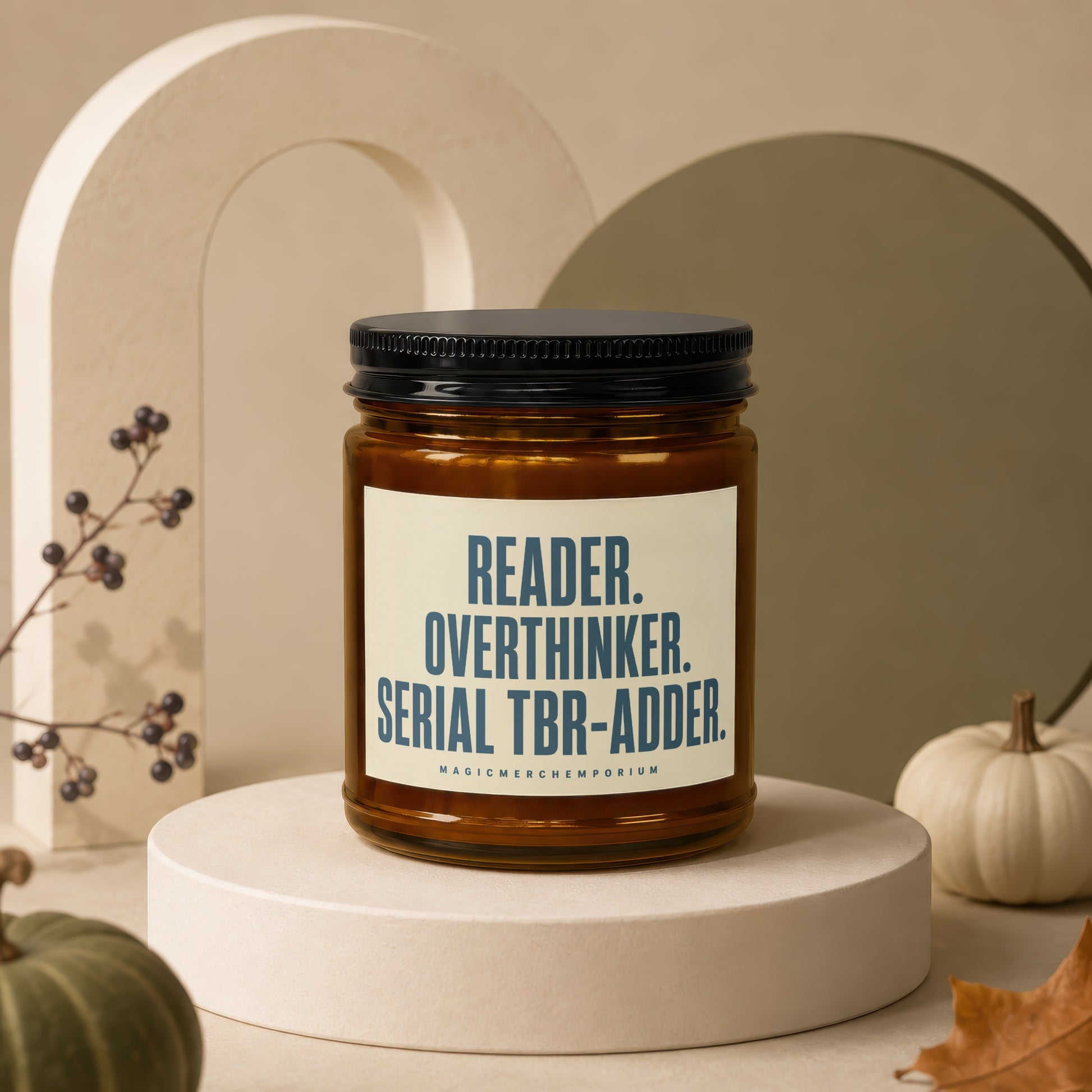 Amber jar candle with black lid reads "Reader. Overthinker. Serial TBR-Adder."