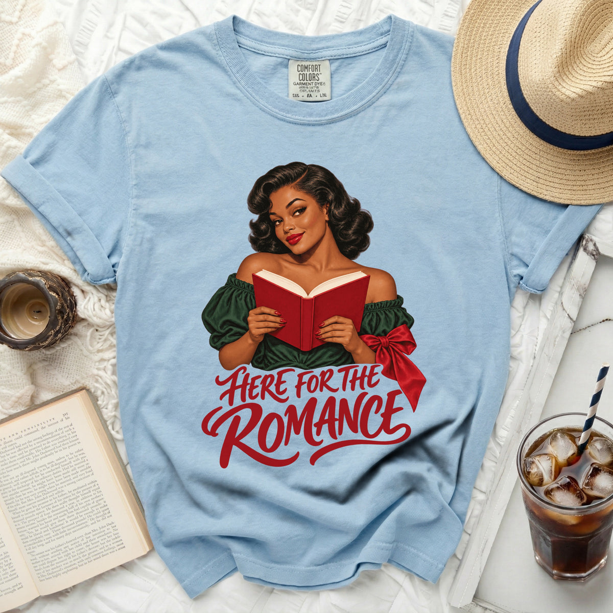 Light blue t-shirt with "HERE FOR THE ROMANCE" graphic featuring a retro woman reading.
