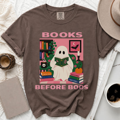Brown t-shirt graphic with ghost reading "BOOKS BEFORE BOOS" and witchy elements.