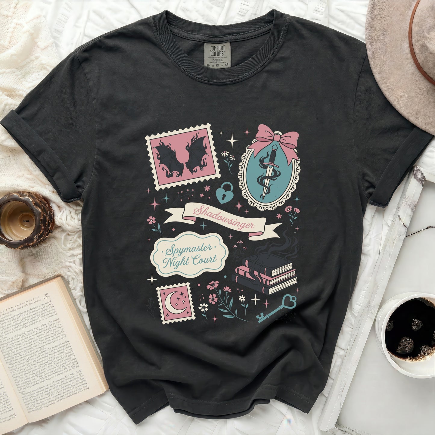 Black t-shirt with "Spymaster Night Court" text and book, sword, and stamp graphics.