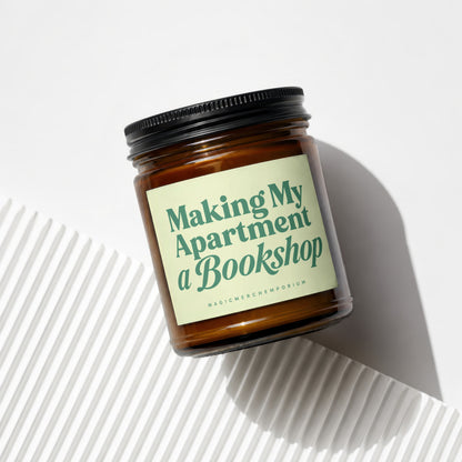 Amber glass candle with a light green label that reads "Making My Apartment a Bookshop."
