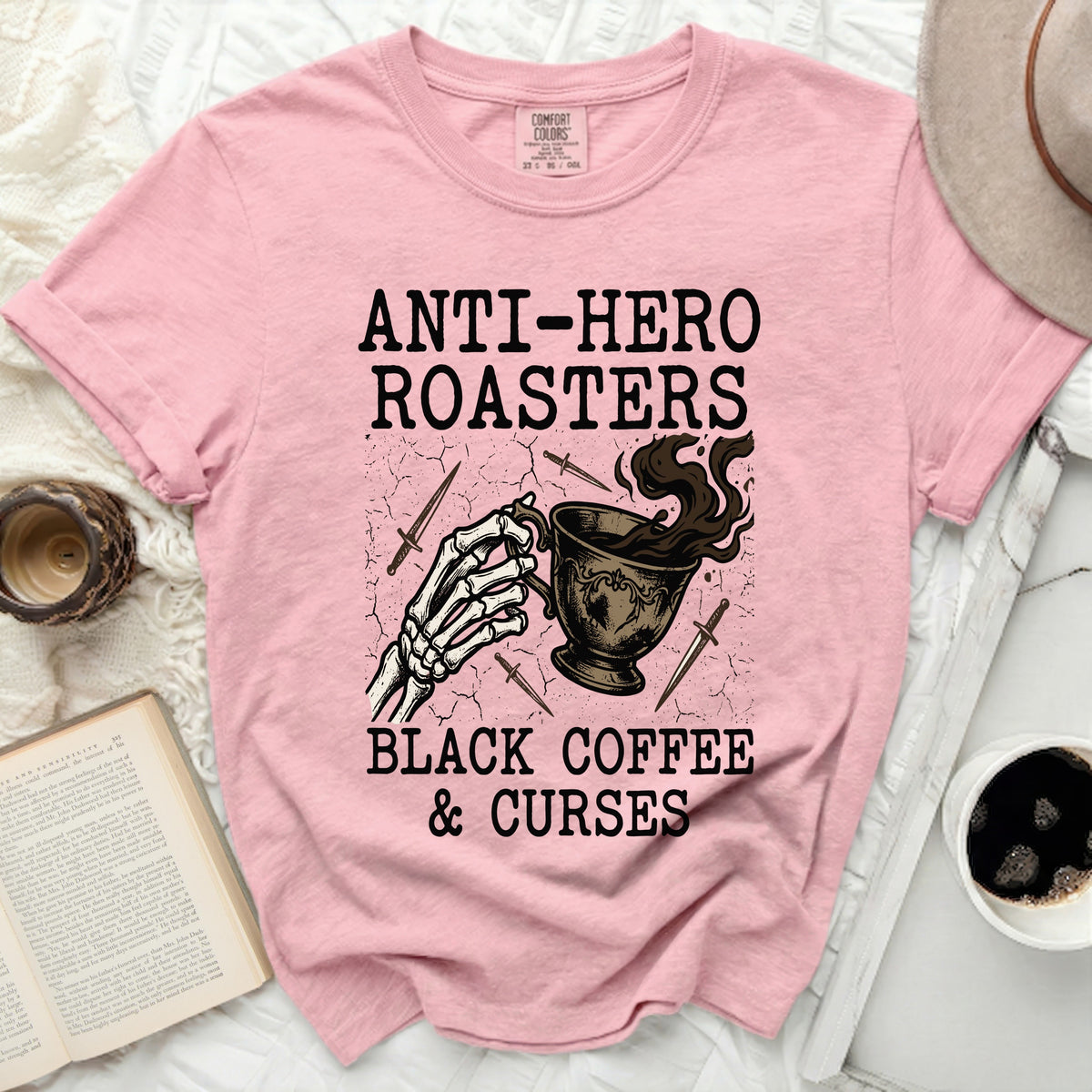 Pink t-shirt with "Anti-Hero Roasters Black Coffee & Curses" graphic.