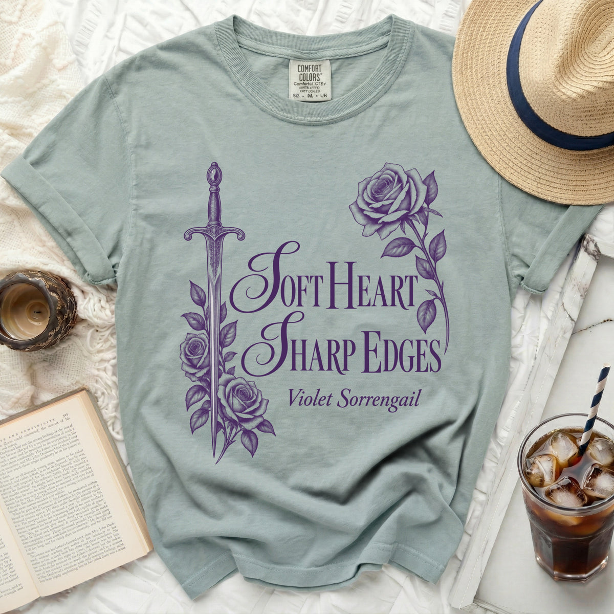Light blue t-shirt with purple graphic of a sword, roses, and text "Soft Heart Sharp Edges Violet Sorrengail".