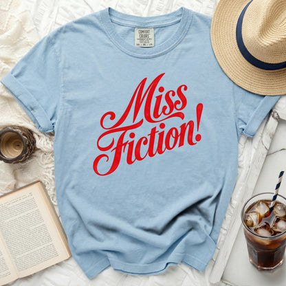 Light blue t-shirt with red "Miss Fiction!" text and Comfort Colors tag.