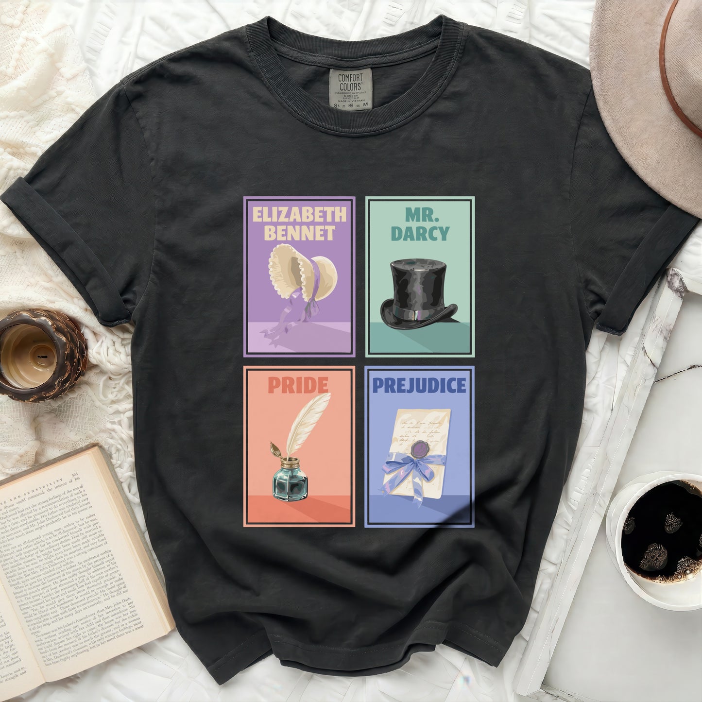Black t-shirt with four illustrated panels: Elizabeth Bennet, Mr. Darcy, Pride, and Prejudice.
