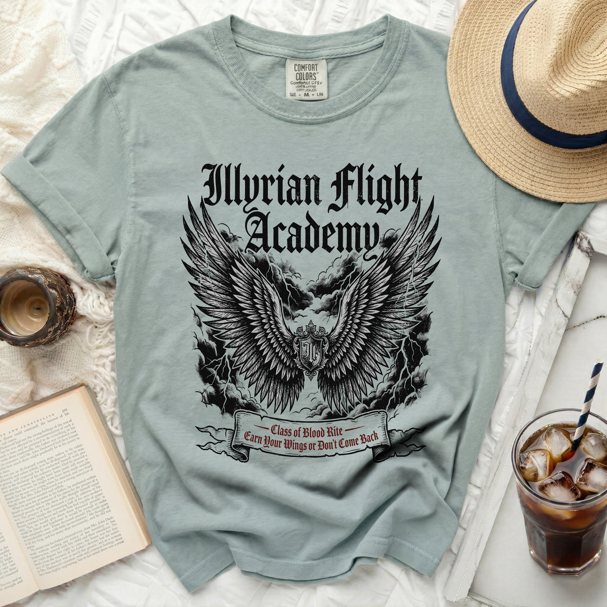 Light blue t-shirt with "Illyrian Flight Academy" text and wings graphic.