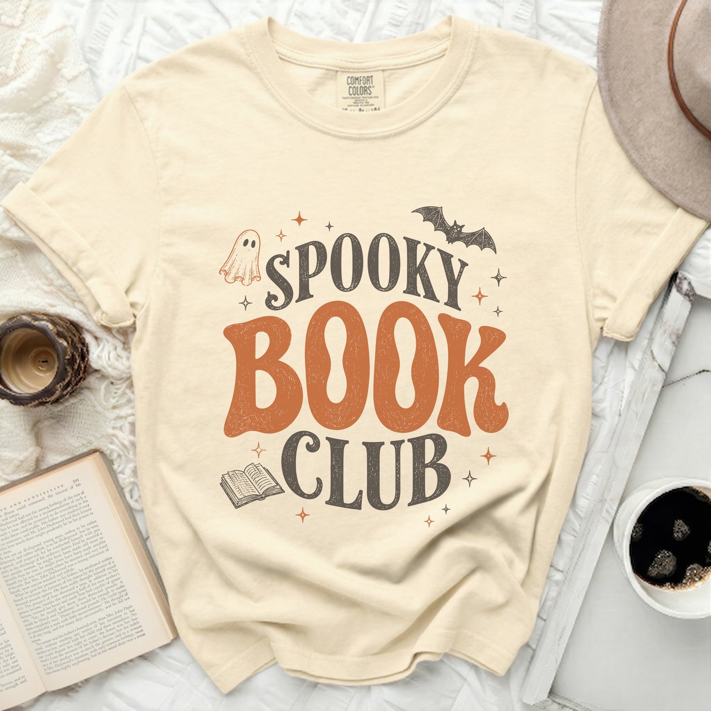 Cream t-shirt with spooky book club graphic, ghost, bat, and book.