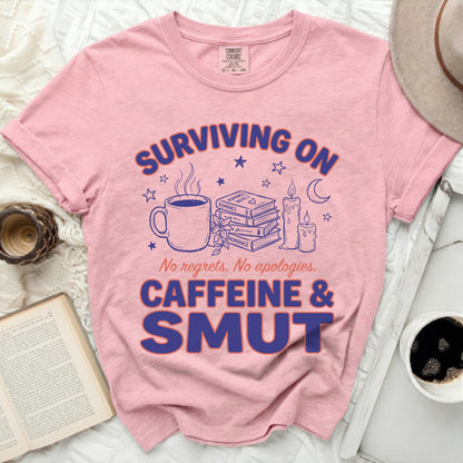 Pink t-shirt with "Surviving on Caffeine & Smut" text and related graphics.