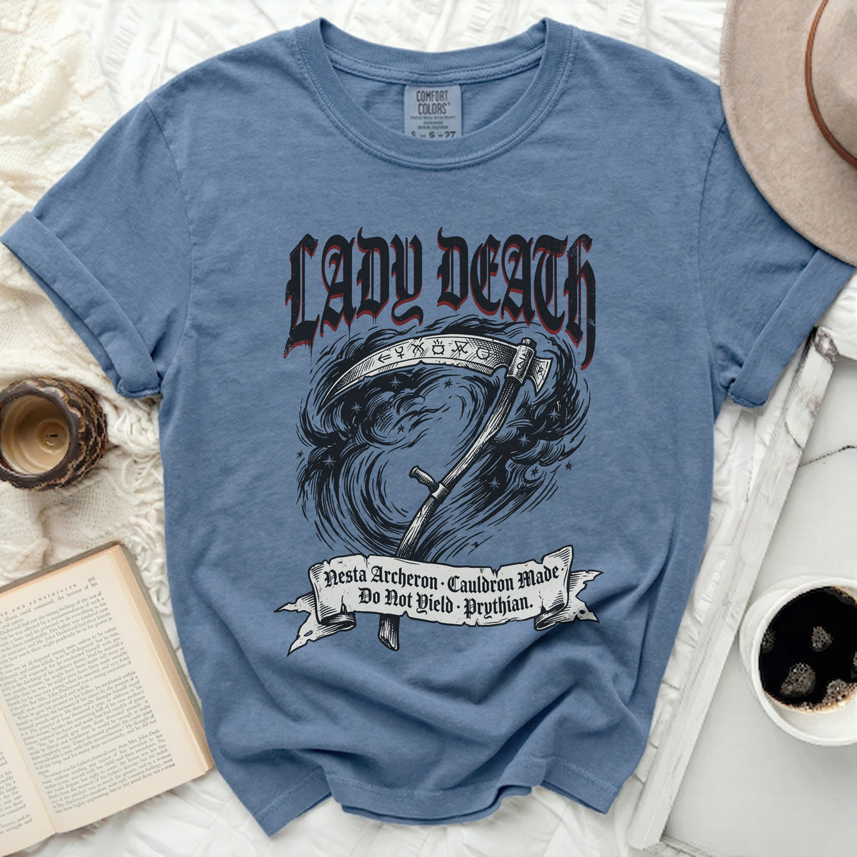 Blue t-shirt with Lady Death, scythe, and text: Nesta Archeron Cauldron Made Do Not Yield Prythian.