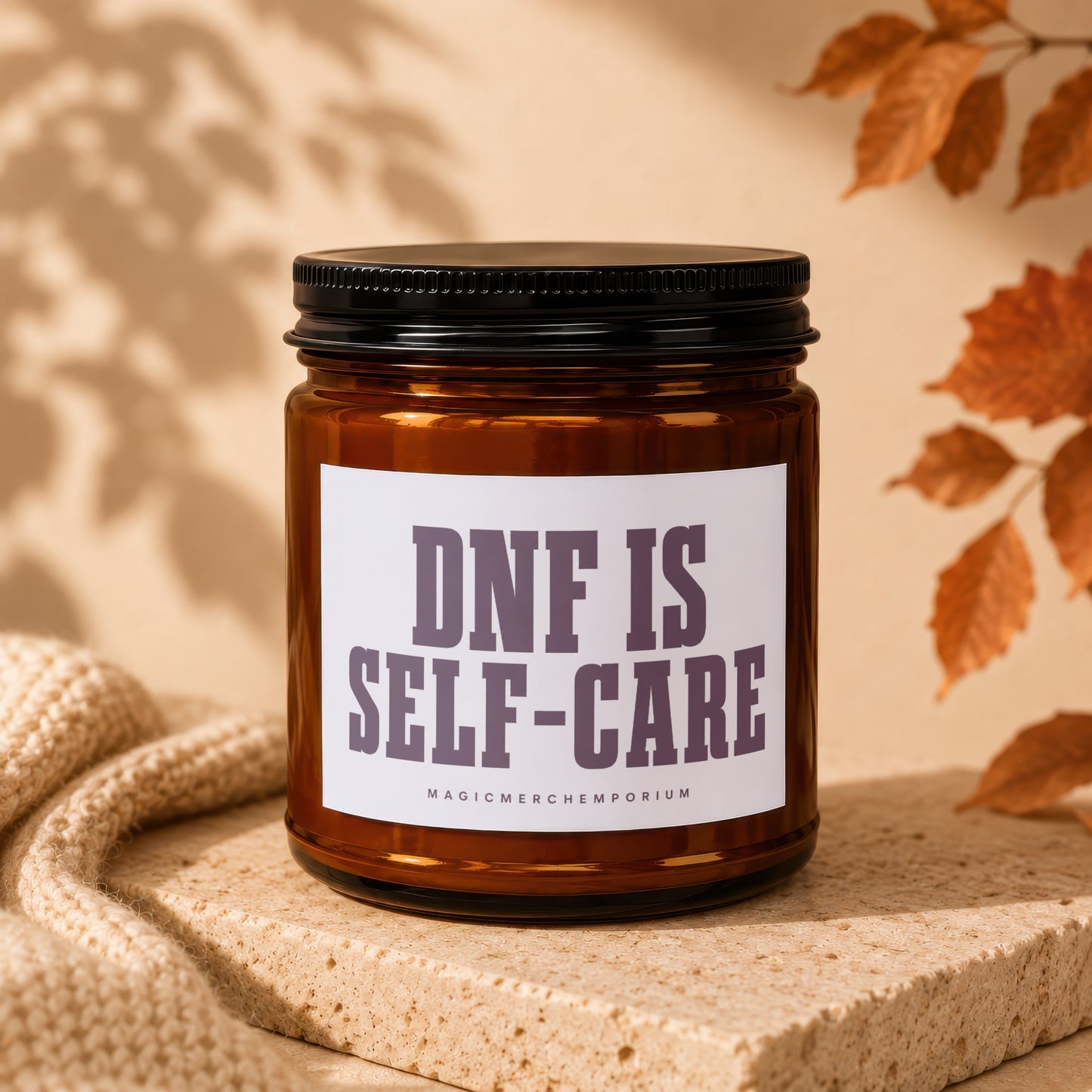 Amber glass candle with label that reads "DNF IS SELF-CARE"