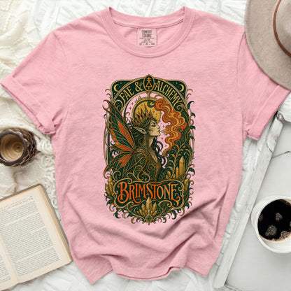 Pink t-shirt with "FAE & Alchemy" and "BRIMSTONE" mystical fairy graphic.