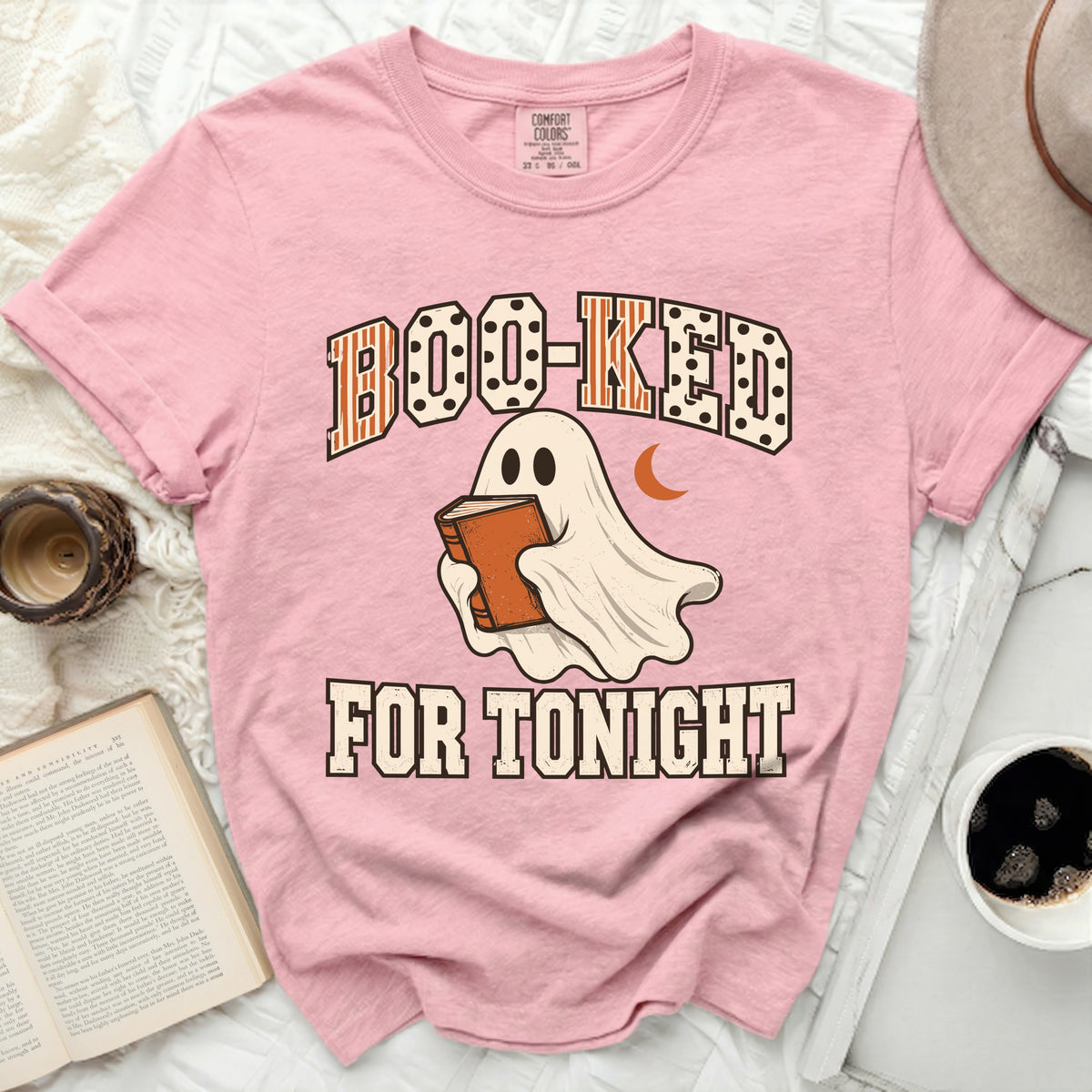 Pink t-shirt with ghost reading book graphic and text "Boo-Ked For Tonight".