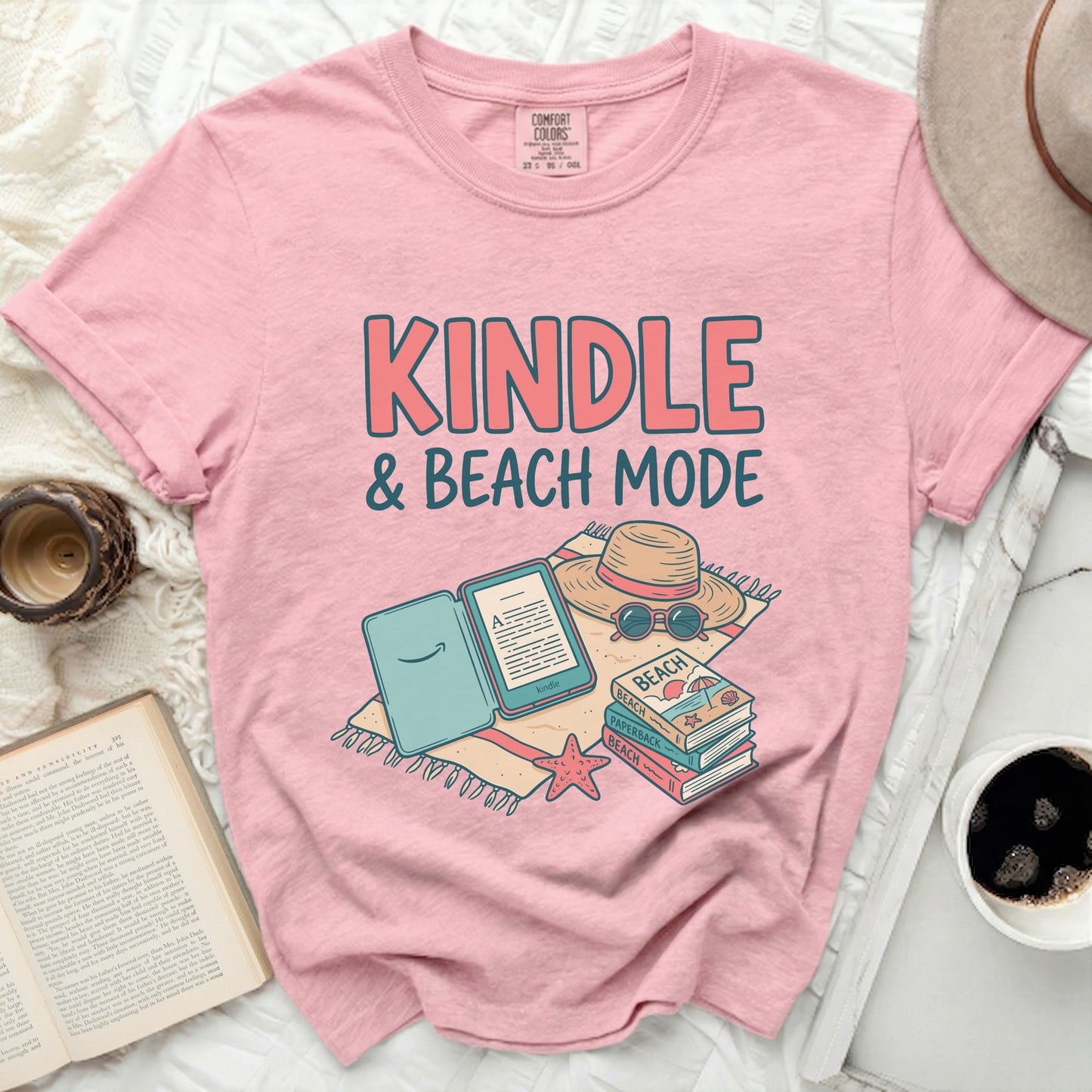 Pink t-shirt with "KINDLE & BEACH MODE" text and book graphic.