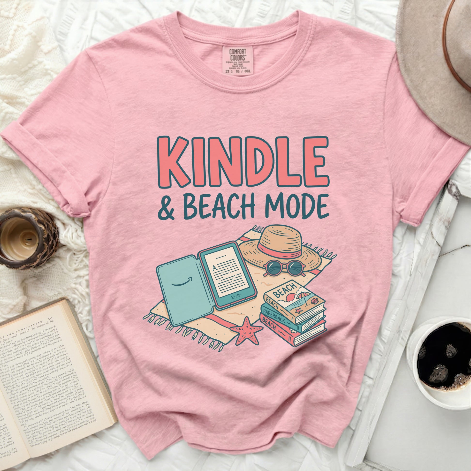 Pink t-shirt with "KINDLE & BEACH MODE" text and book graphic.