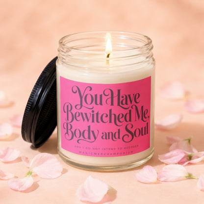 Candle with text "You Have Bewitched Me, Body and Soul" on pink label.
