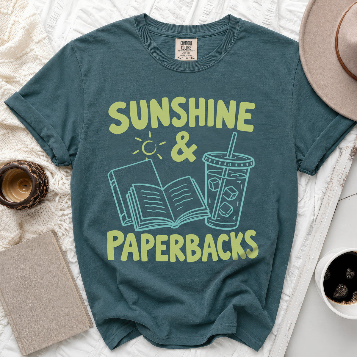 Teal Comfort Colors t-shirt with "Sunshine & Paperbacks" graphic.