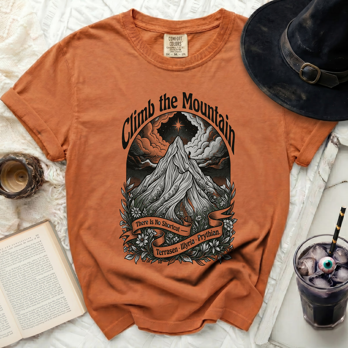 Orange t-shirt with "Climb the Mountain" graphic and text "There Is No Shortcut."