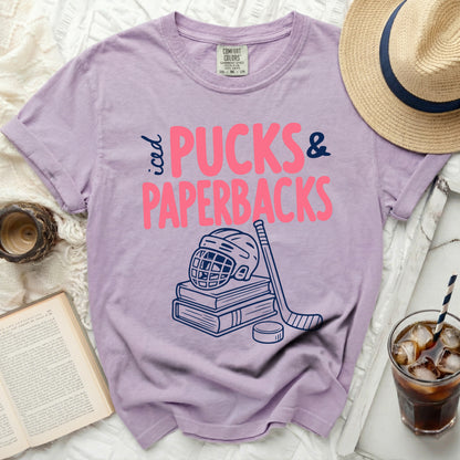 Purple t-shirt with "iced PUCKS & PAPERBACKS" and hockey gear.