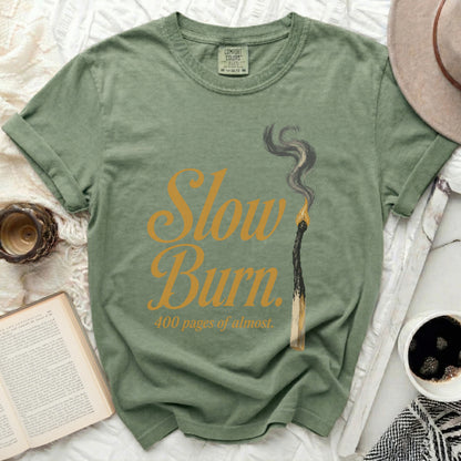 Green t-shirt with "Slow Burn 400 pages of almost" text and burnt match graphic.