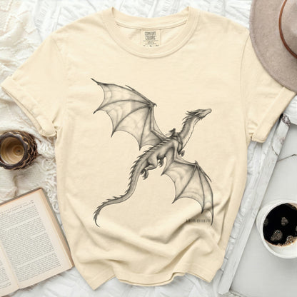 Beige t-shirt with a graphite drawing of a winged dragon and rider.