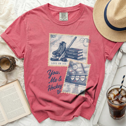 T-shirt with "You, Me & Hockey" graphic featuring ice skates and stamps.