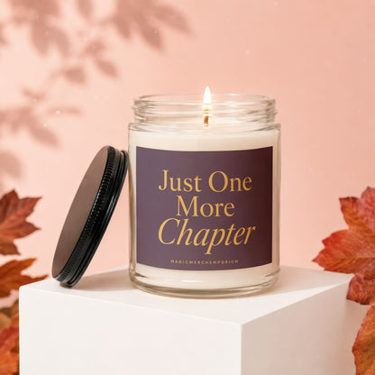 Glass candle with purple label reading "Just One More Chapter".