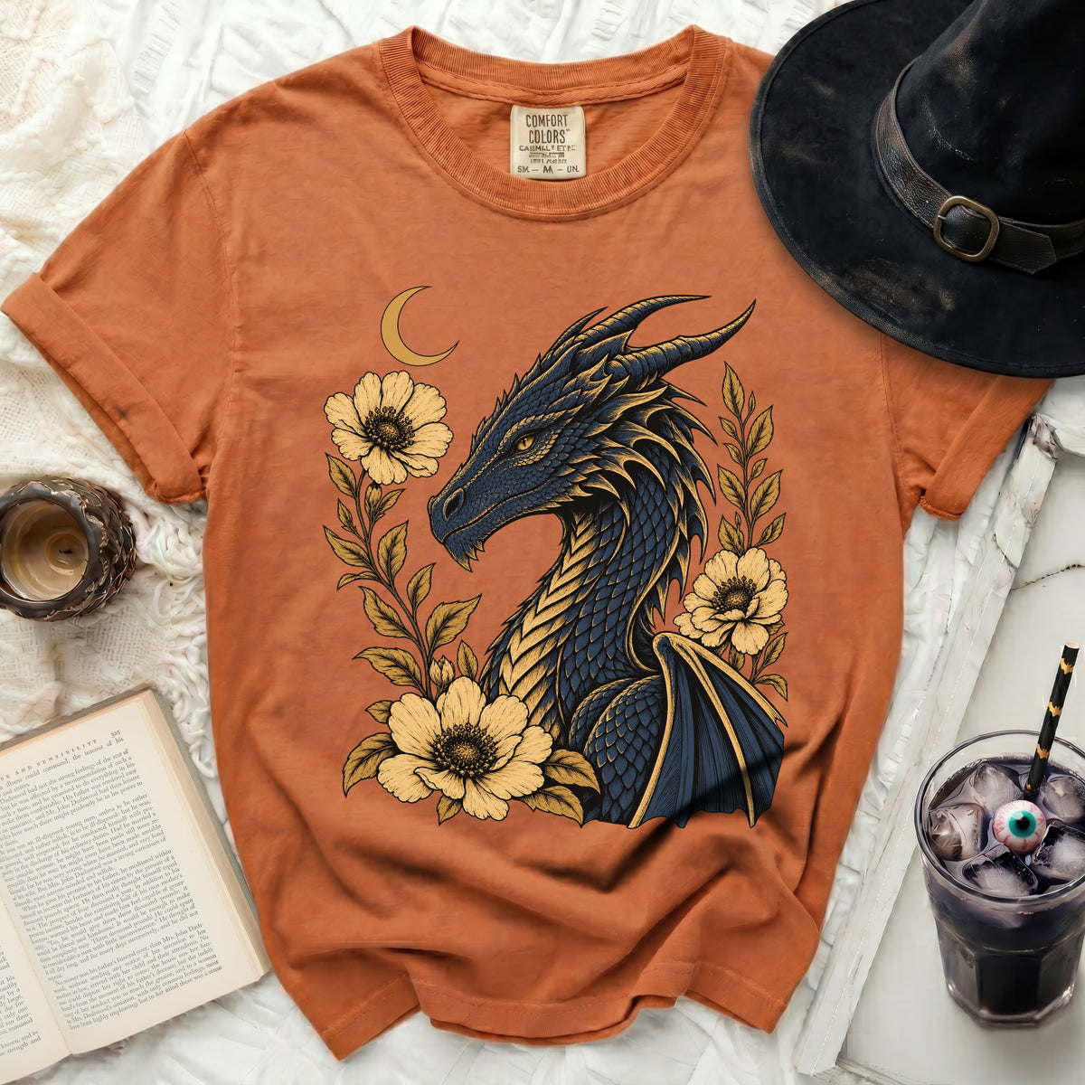 Orange t-shirt with a dark blue dragon and yellow flowers graphic.