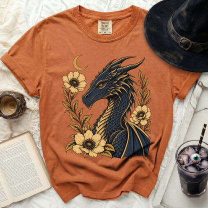 Orange t-shirt with a dark blue dragon and yellow flowers graphic.