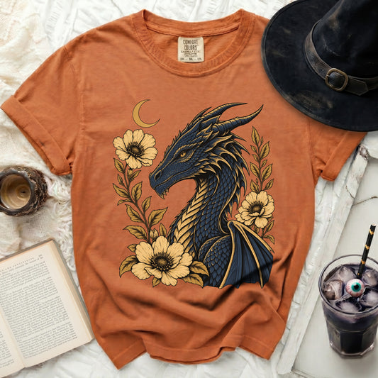Orange t-shirt with a dark blue dragon and yellow flowers graphic.