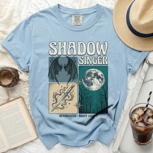 Blue t-shirt with "Shadow Singer" graphic featuring wings, sword, and moon.
