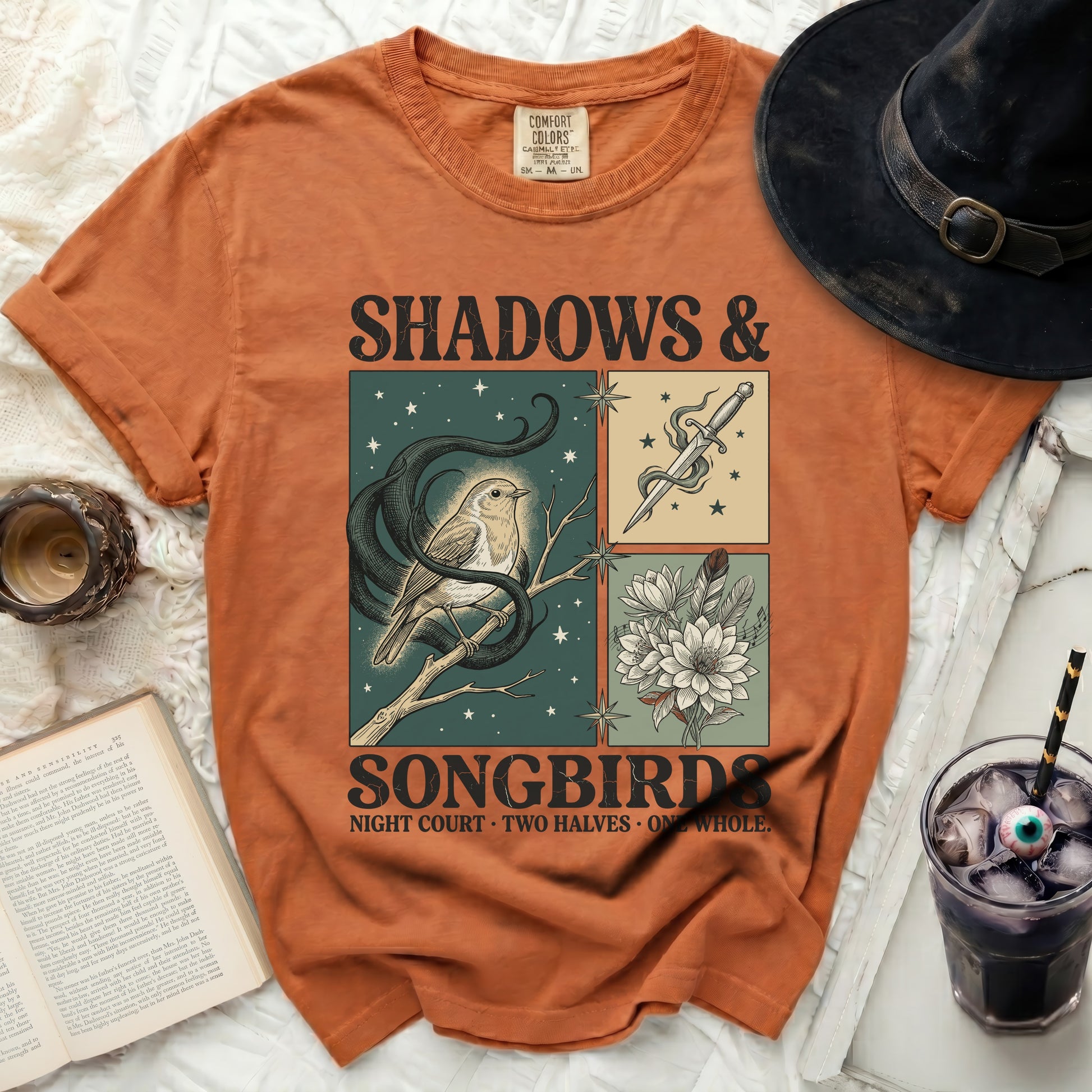 Orange t-shirt with "Shadows & Songbirds" graphic of a bird and dagger.