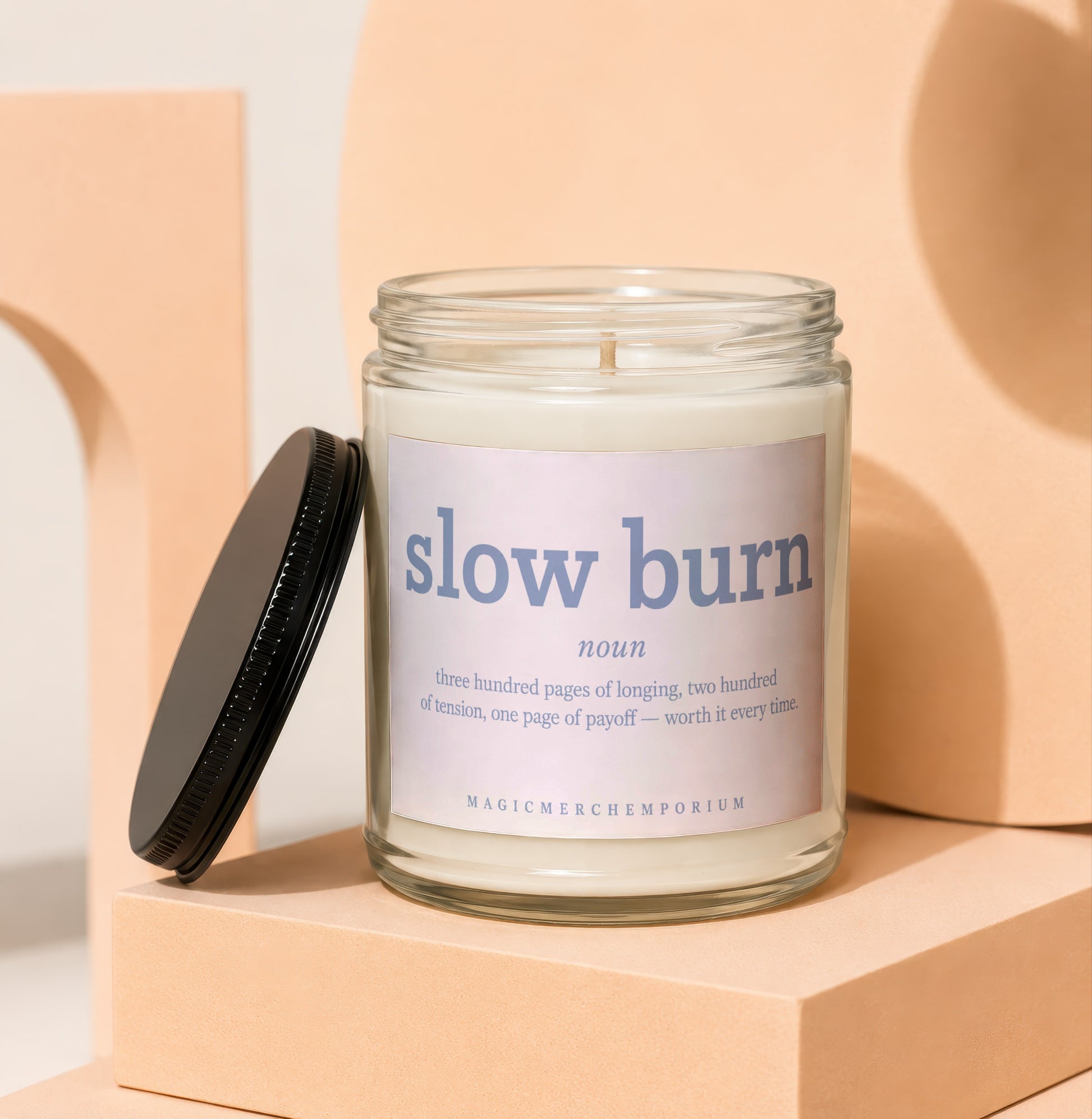 Glass candle with a label reading "slow burn" and its definition.