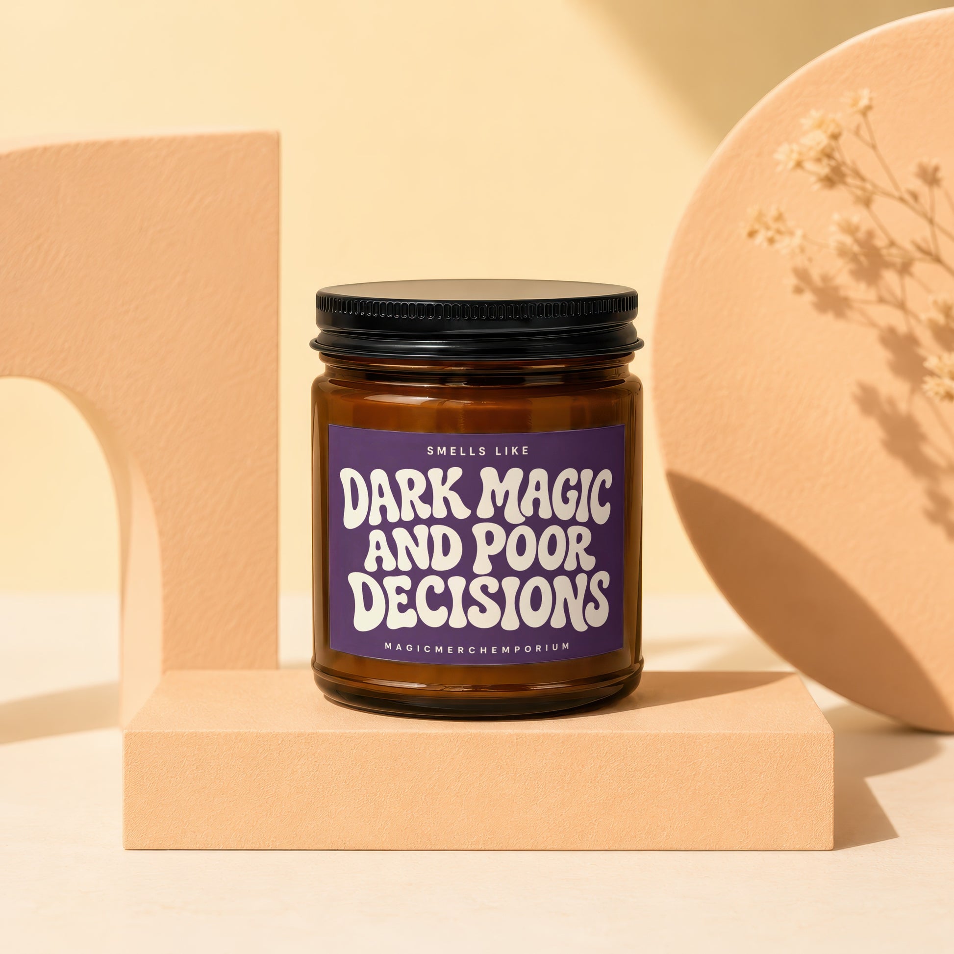 Brown glass jar candle labeled "Dark Magic and Poor Decisions" on a pedestal.