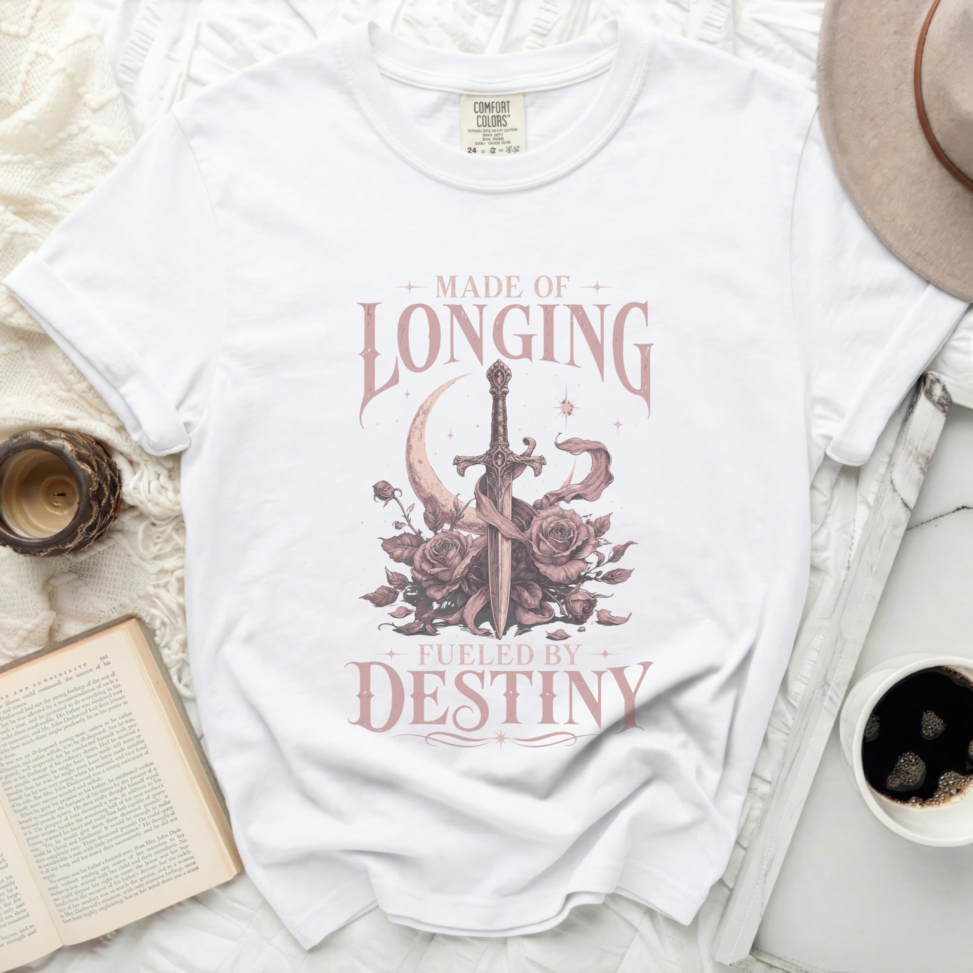 White t-shirt with "Made of Longing, Fueled by Destiny" and sword graphic.