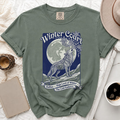 Olive green t-shirt with a wolf howling at the moon graphic titled "Winter Court."