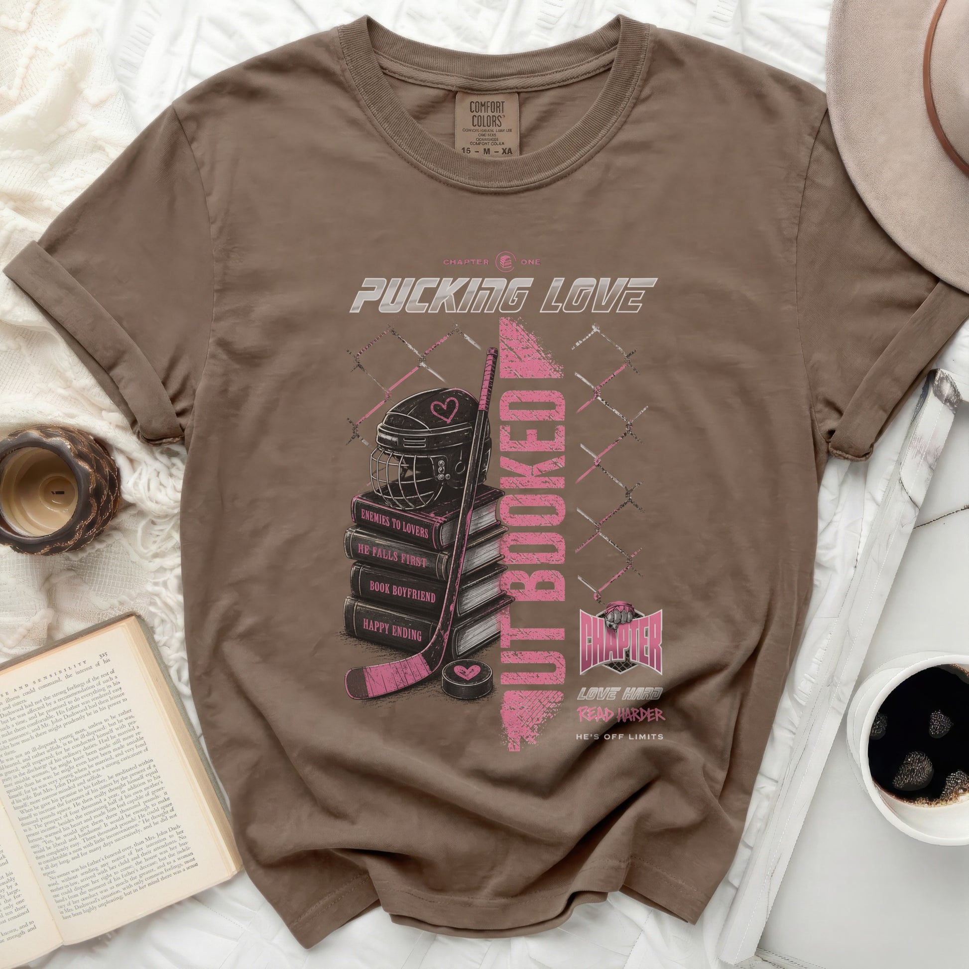 Brown t-shirt with "Pucking Love" text, hockey rink, and book graphics.