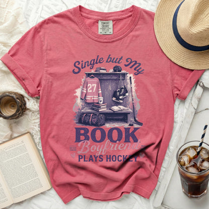 Pink t-shirt with "Single but My Boyfriend Plays Hockey" text and hockey gear.
