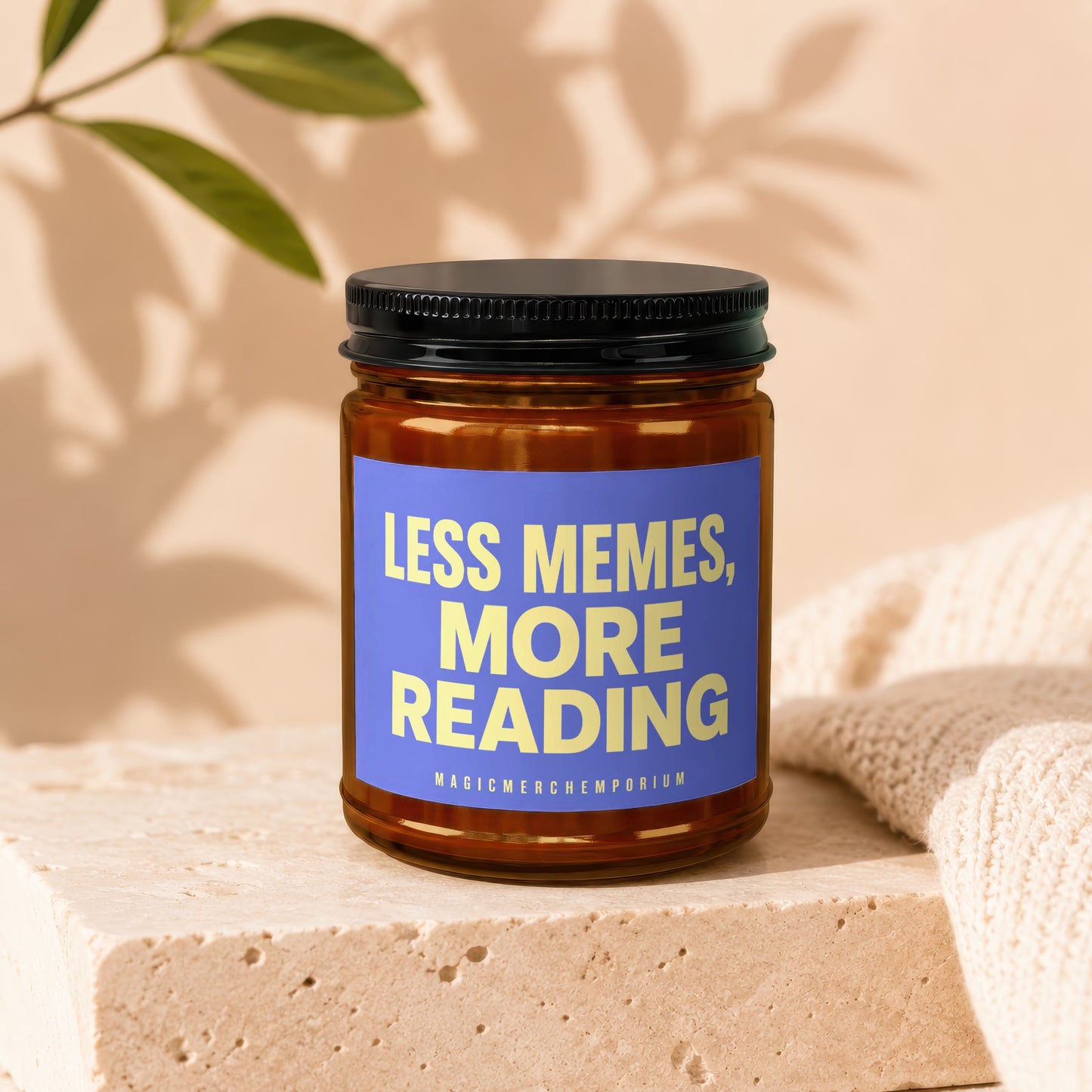 Amber jar candle with blue label reading "LESS MEMES, MORE READING".