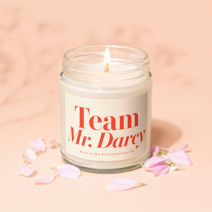 Lit candle in a glass jar with "Team Mr. Darcy" text on the label.