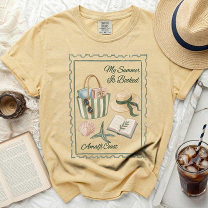 Yellow t-shirt with "My Summer Is Booked" and Amalfi Coast graphic.